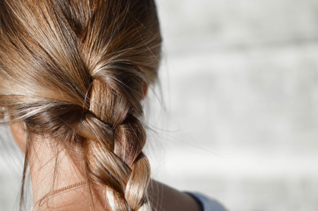 Close up image of a woman with plaited hair