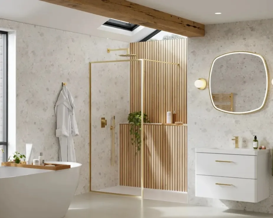 image of a light bathroom with white features, wooden panelling, and brass shower enclosure and freestanding bath illustrating home spa style