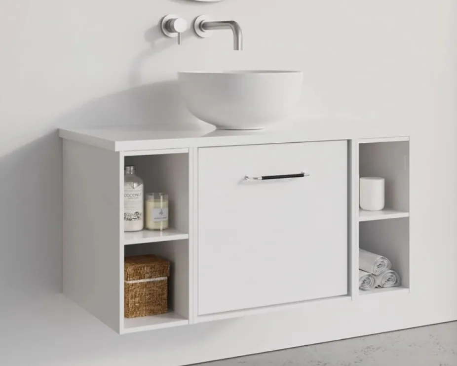 image of an all white vanity unit with chrome handle, white walls, and white countertop basin