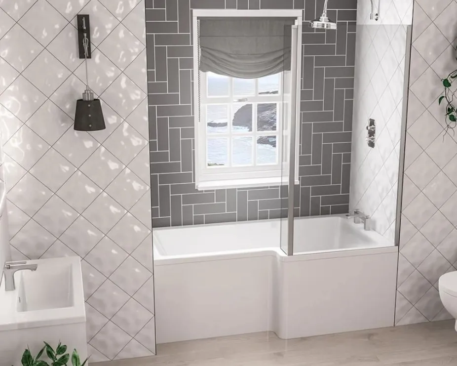 image of a l-shaped bath with chrome fixtures in a grey parquet tiled space and white and grey fixtures