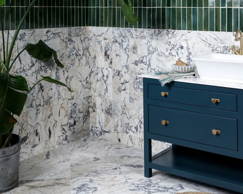 image of a bathroom with marble tiles and blue floorstanding 2 drawer vanity unit