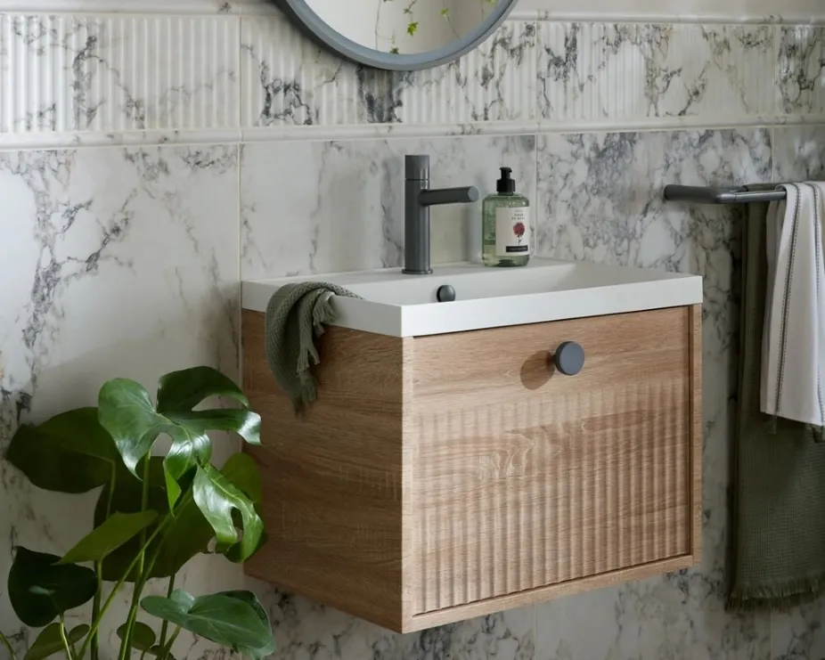 image of a wooden fluted single drawer vanity unit in marble tiled bathroom
