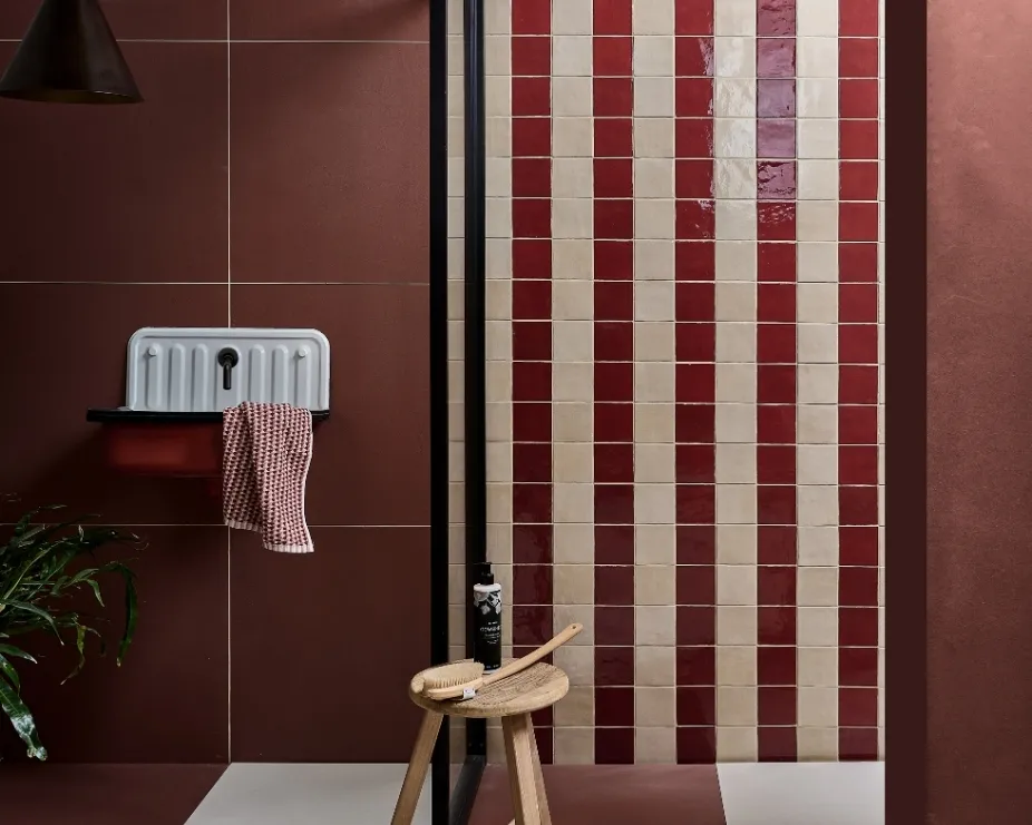 image of a dark red bathroom with red and white mosaic tiles and a red sink