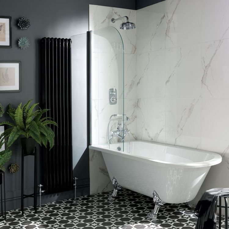 Lifestyle image of a bathroom with white marble wall tiles around its freestanding roll top bath