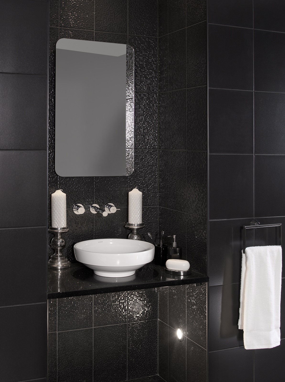 Lifestyle image of a black bathroom design, featuring differently textured black wall tiles