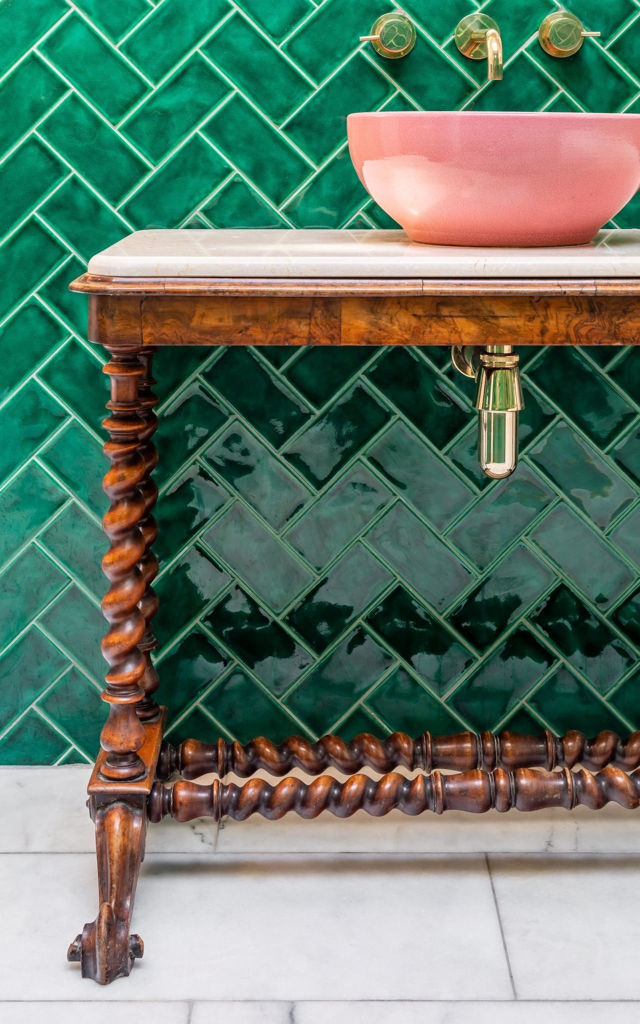 Close up image of an ornate brown wooden washbasin stand