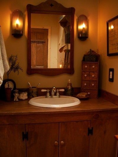 Close up image of a wooden wasbasin unit and wooden framed mirror
