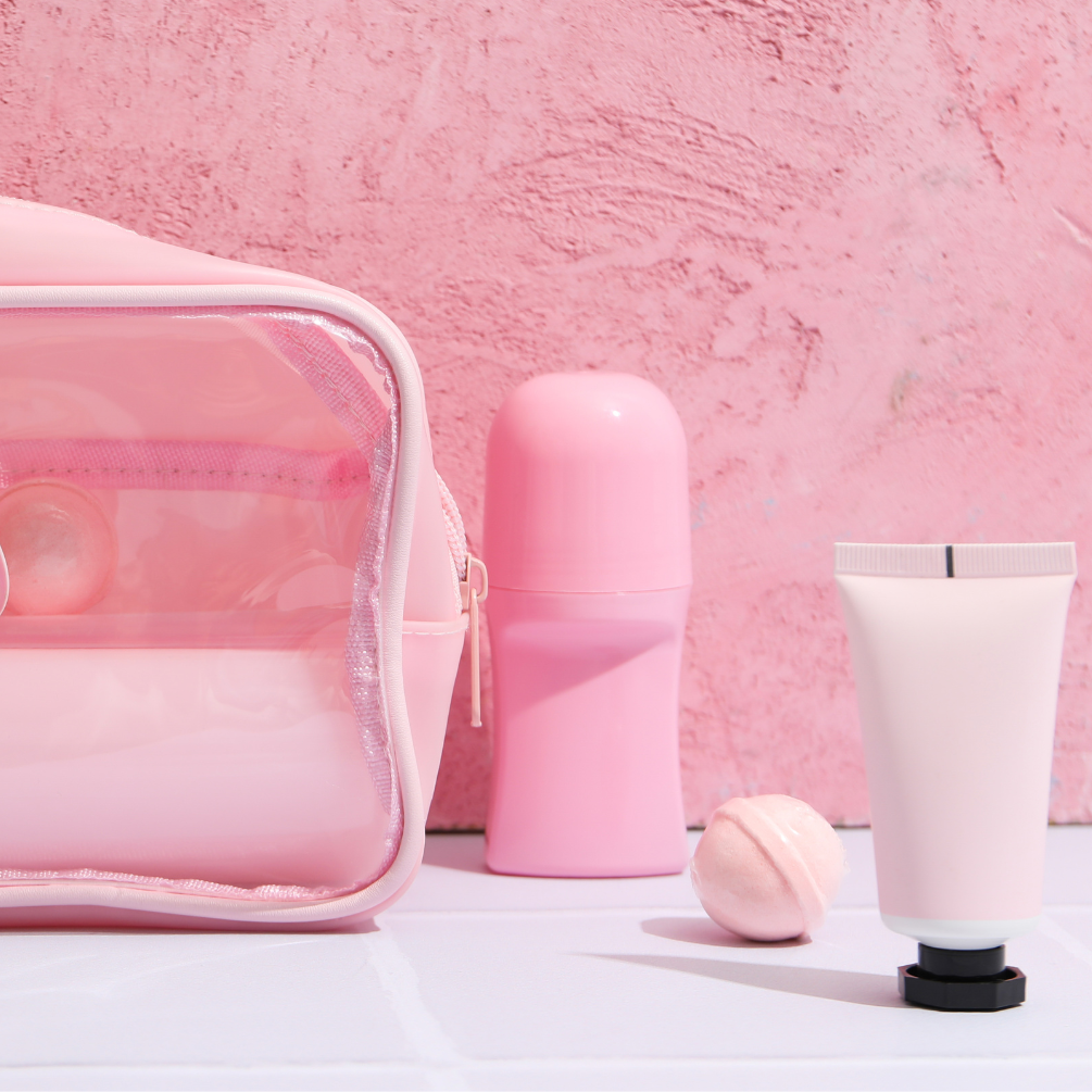 image of pink bathroom products including bottles and bath bomb