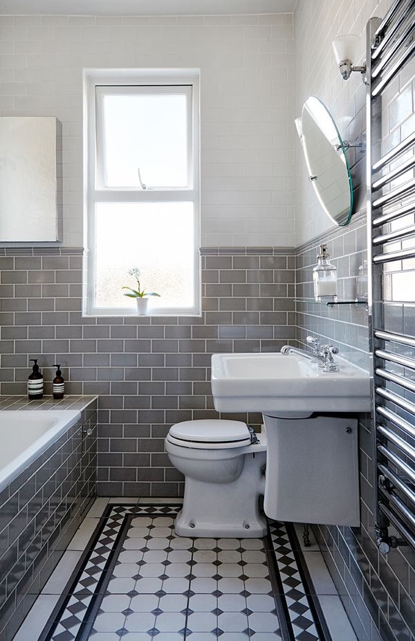 Lifestyle image of an Edward style bathroom, with black and white patterned floor tiles, grey and white wall tiles, a wall hung semi pedestal basin and open back toilet with concealed cistern
