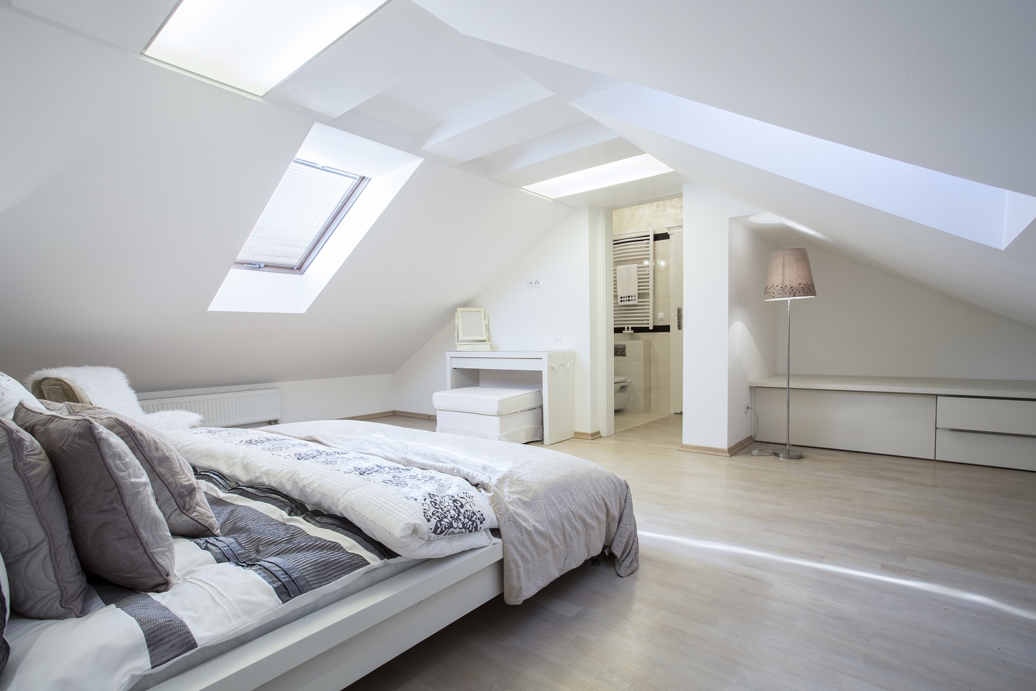 Lifestyle image a large attic bedroom with an ensuite