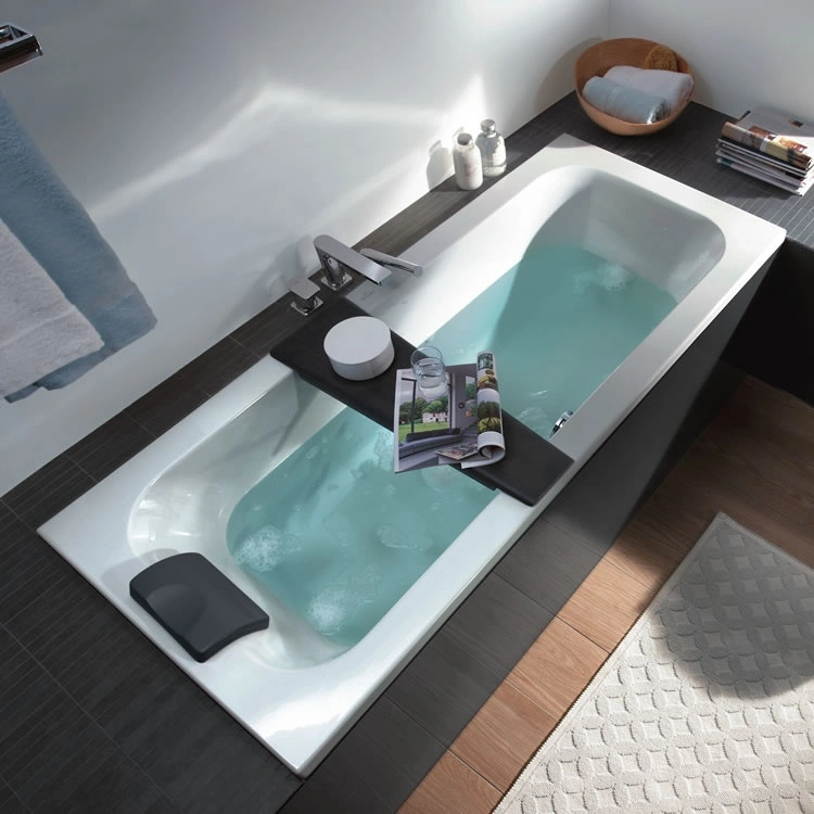 image of an inset bath filled with water with bath rack and magazine