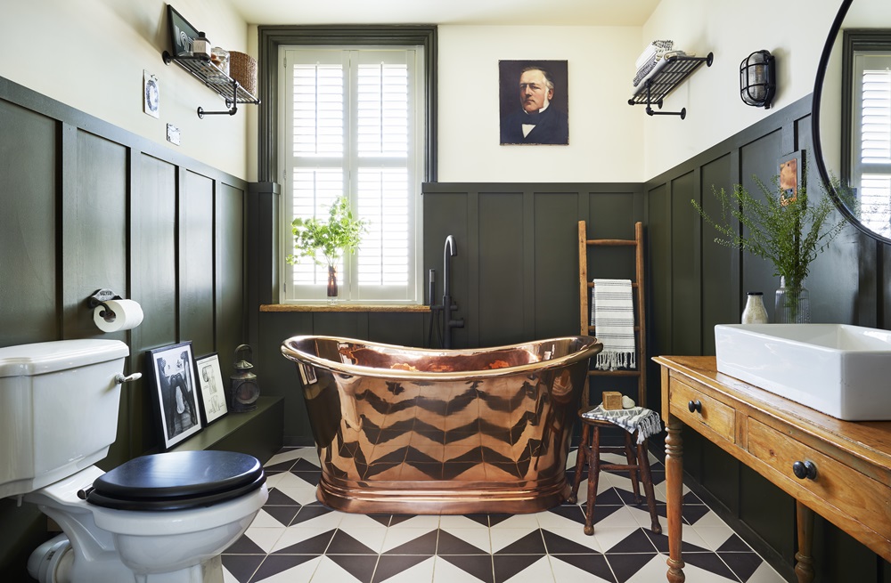 image of retro bathroom with wall mounted towel rails and copper freestanding boat bath - photographer Darren Chung