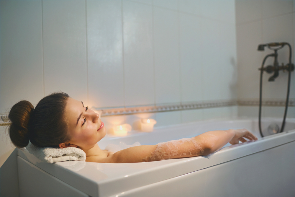 Lifestyle image of a woman relaxing in a bubble bath