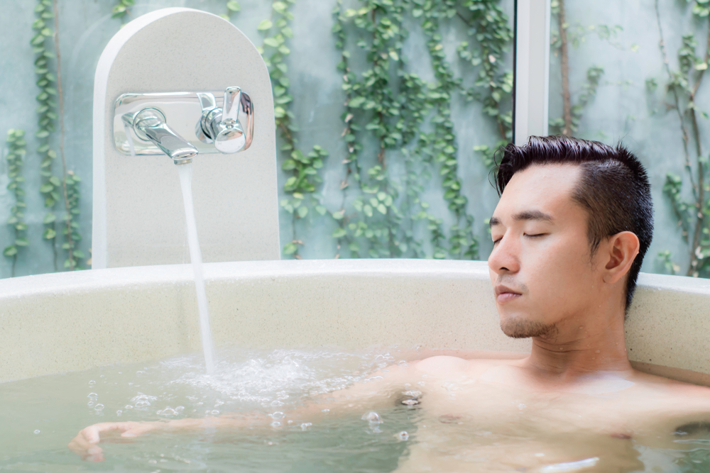 Lifestyle image of a man relaxing in a hot bath