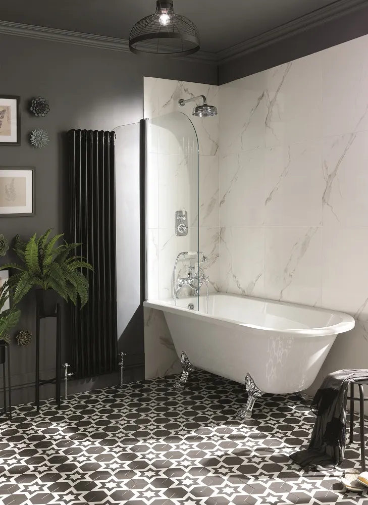 image of bayswater traditional freestanding shower bath with screen in a hexagonal and star tiled floor with large black traditional vertical radiator