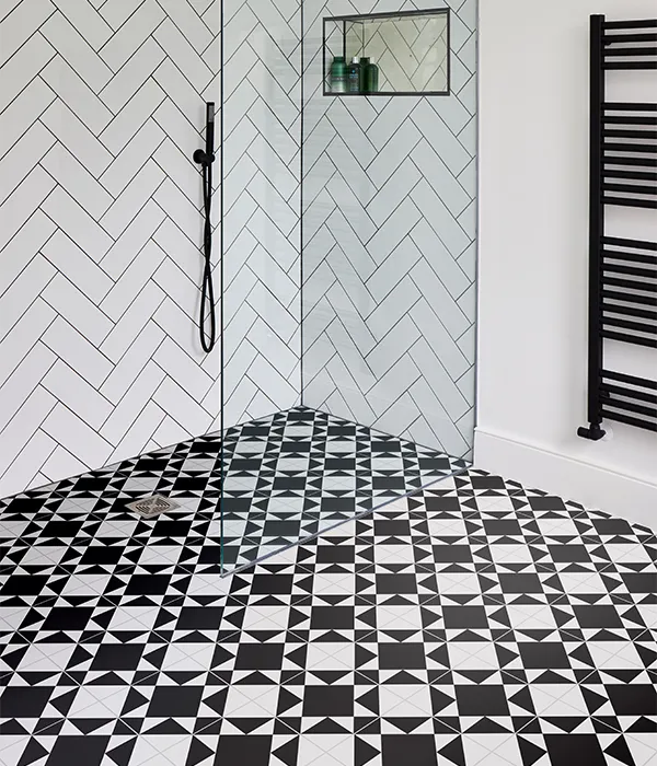 image of ca' pietra brompton underground patterned black and white tiles in shower space with white herringbone / parquet tiled walls