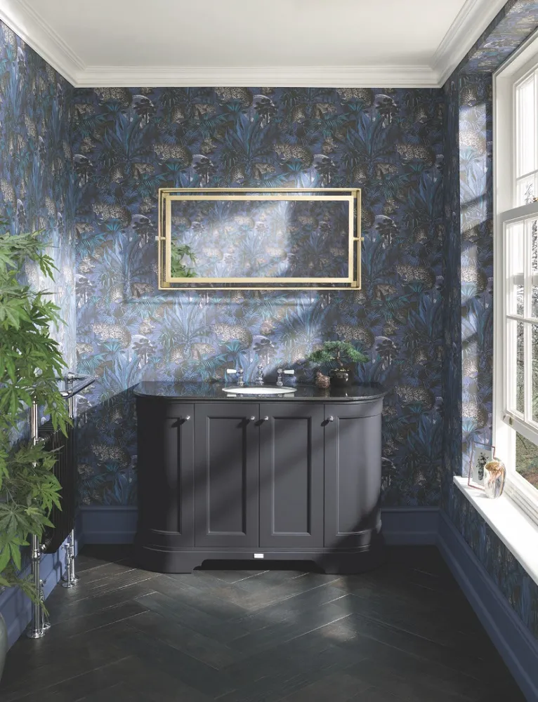 image of bayswater black curved vanity unit with black worktop and basin with black traditional radiator and decorative plants. Blue patterned wallpaper
