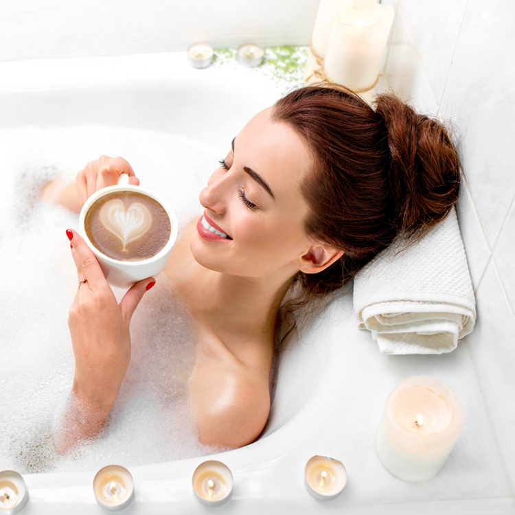 Lifestyle image of a woman drinking a coffee in the bath