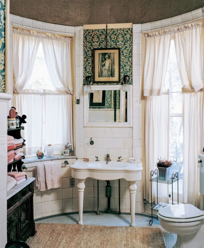 Lifestyle image of a Victorian style bathroom, with a decorative washstand and curvaceous washbasin