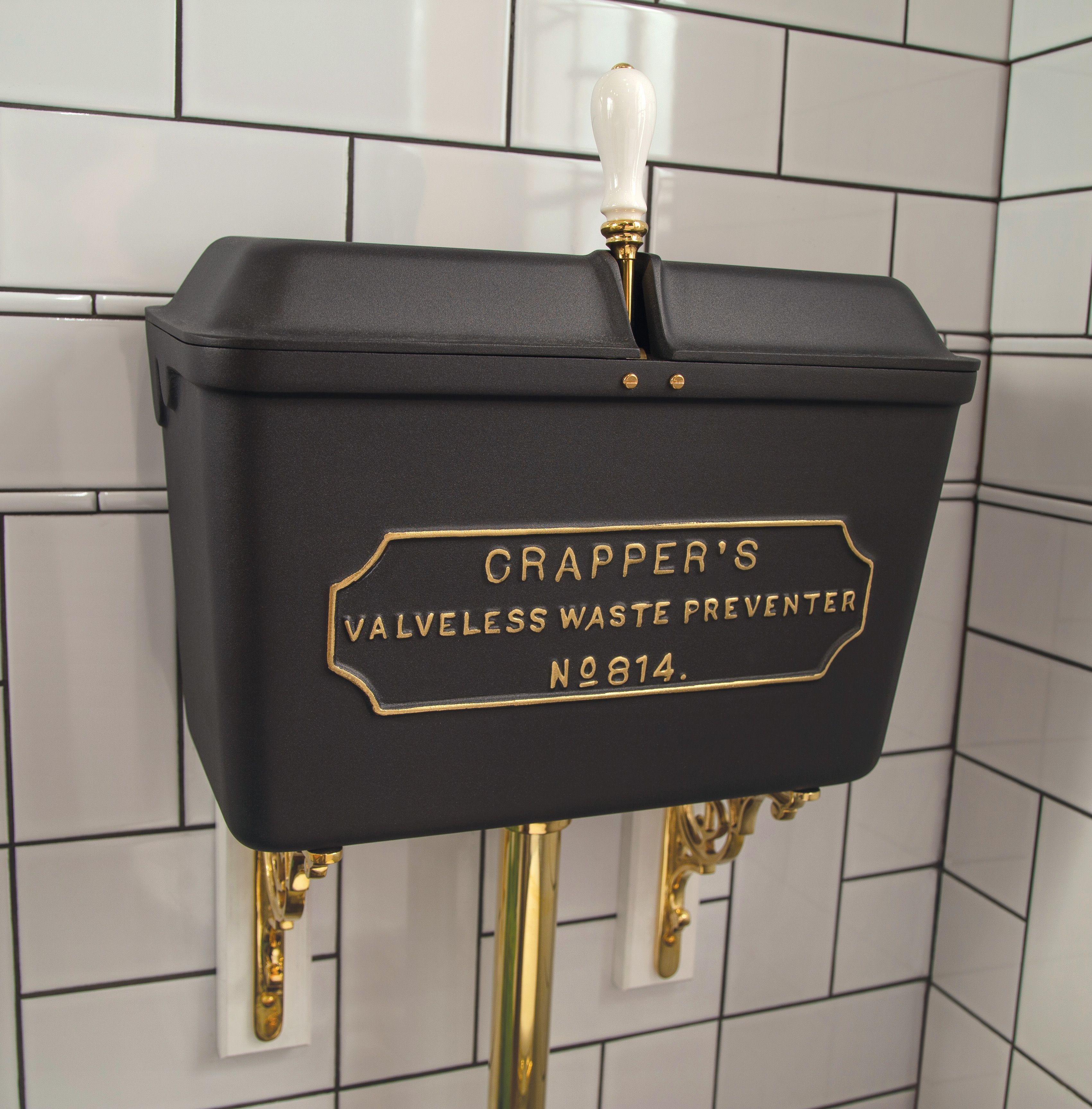 Close up image of a low level cast iron cistern, featuring the Thomas Crapper trademark 