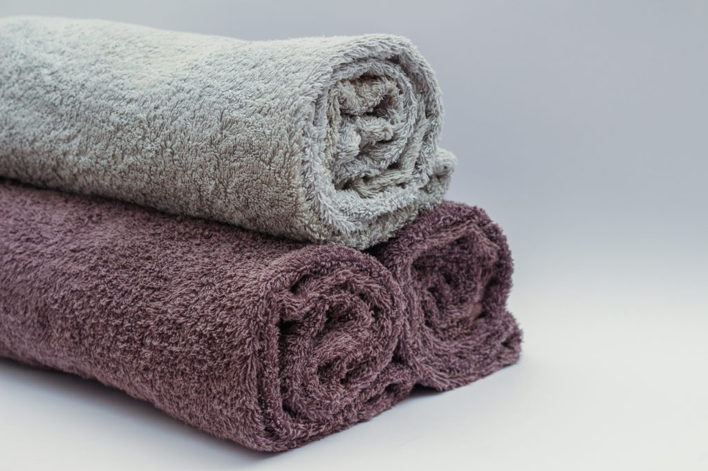 Close up image of three rolled up towels