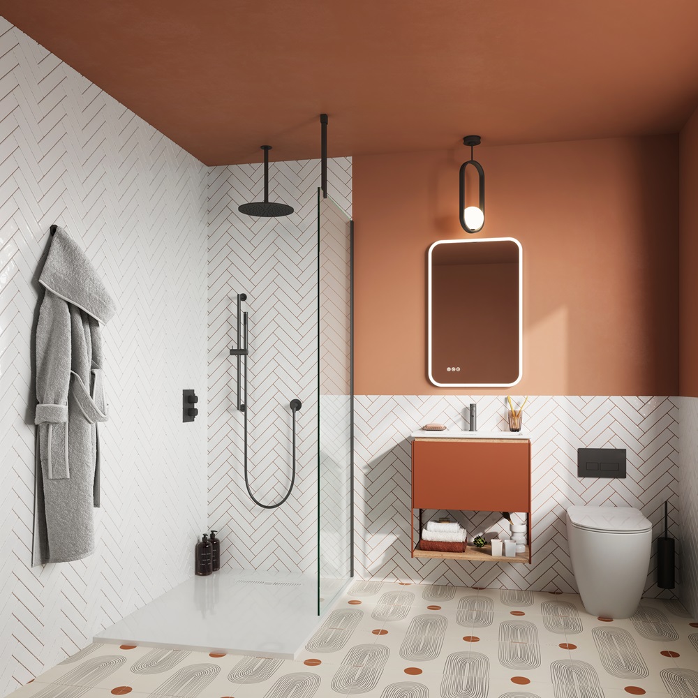 image of an orange coloured en suite bathroom with a walk in shower, orange vanity unit and basin, and back to wall toilet with white herringbone tiled wall
