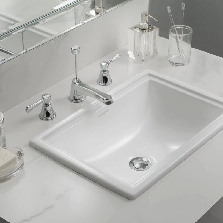 image of a drop in basin with rim on a white marble worktop surface