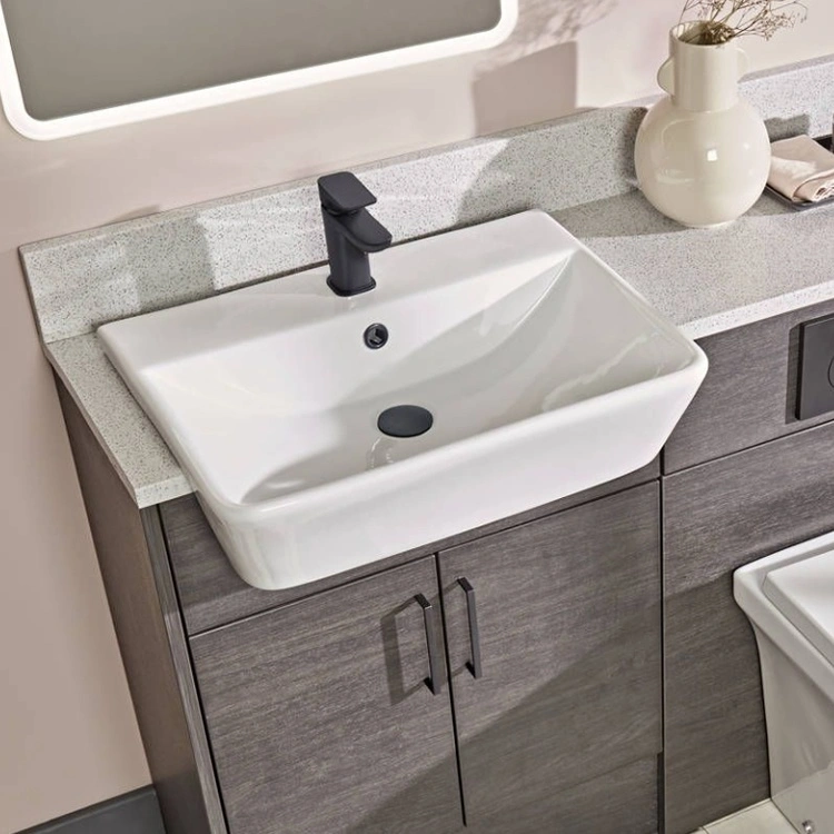 image of a semi recessed or semi inset basin semi recesed into grey wood furniture with matt black mono tap and waste