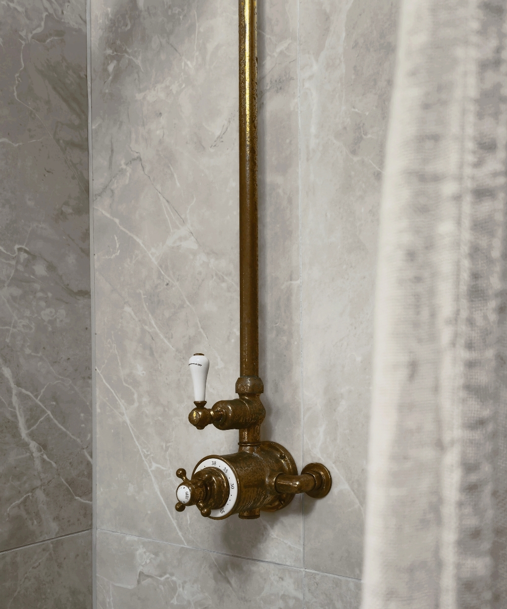 crosswater belgravia thermostatic exposed shower valve and rigid rier kit with 8 inch fixed shower head in unlacquered brass close up