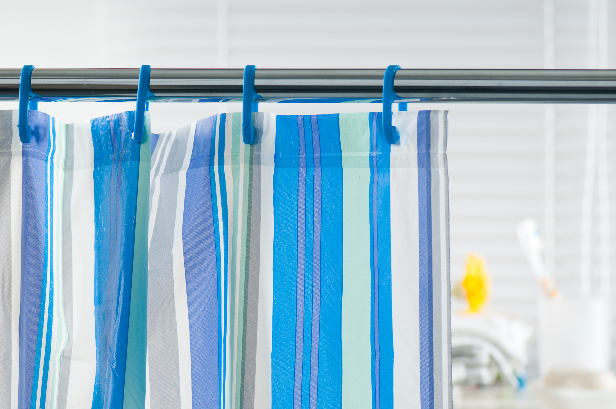 Close up image of a blue and white striped shower curtain