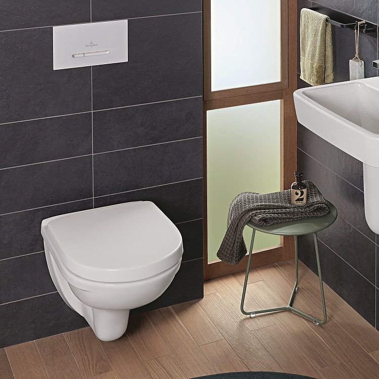 image of villeroy and boch o.novo wall hung toilet with white flush plate on blue large tiled wall with wooden laminate flooring and a frosted glass window at side