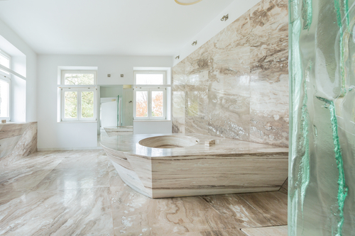 Lifestyle image of a bathroom with marble across its floor and walls