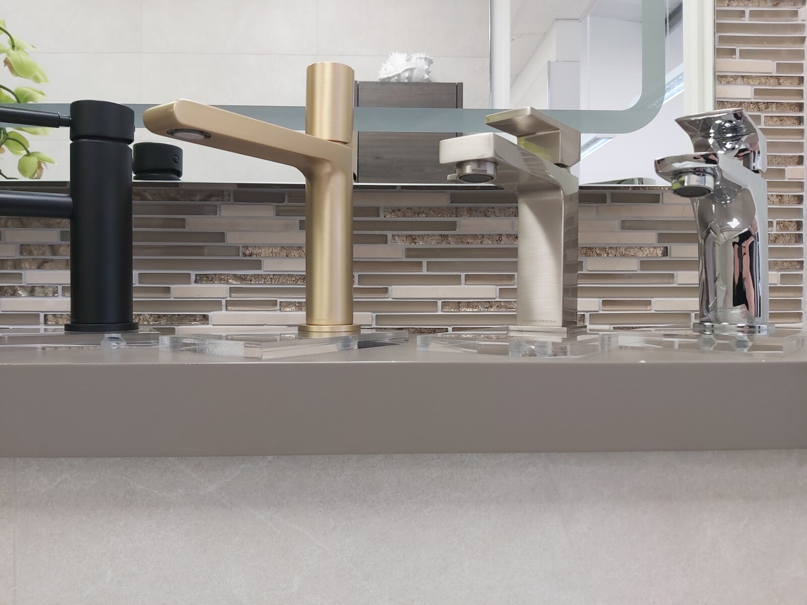 Image of a selection of different tap finishes in a bathroom showroom