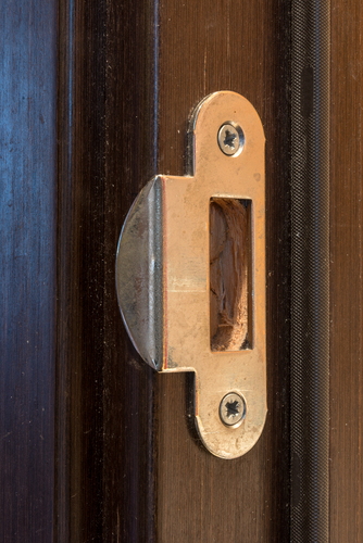 Close up image of a strikplate attached to a door jamb