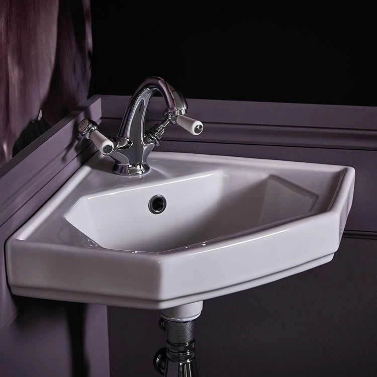 image of a corner wall hung basin with overflow hole clearly shown