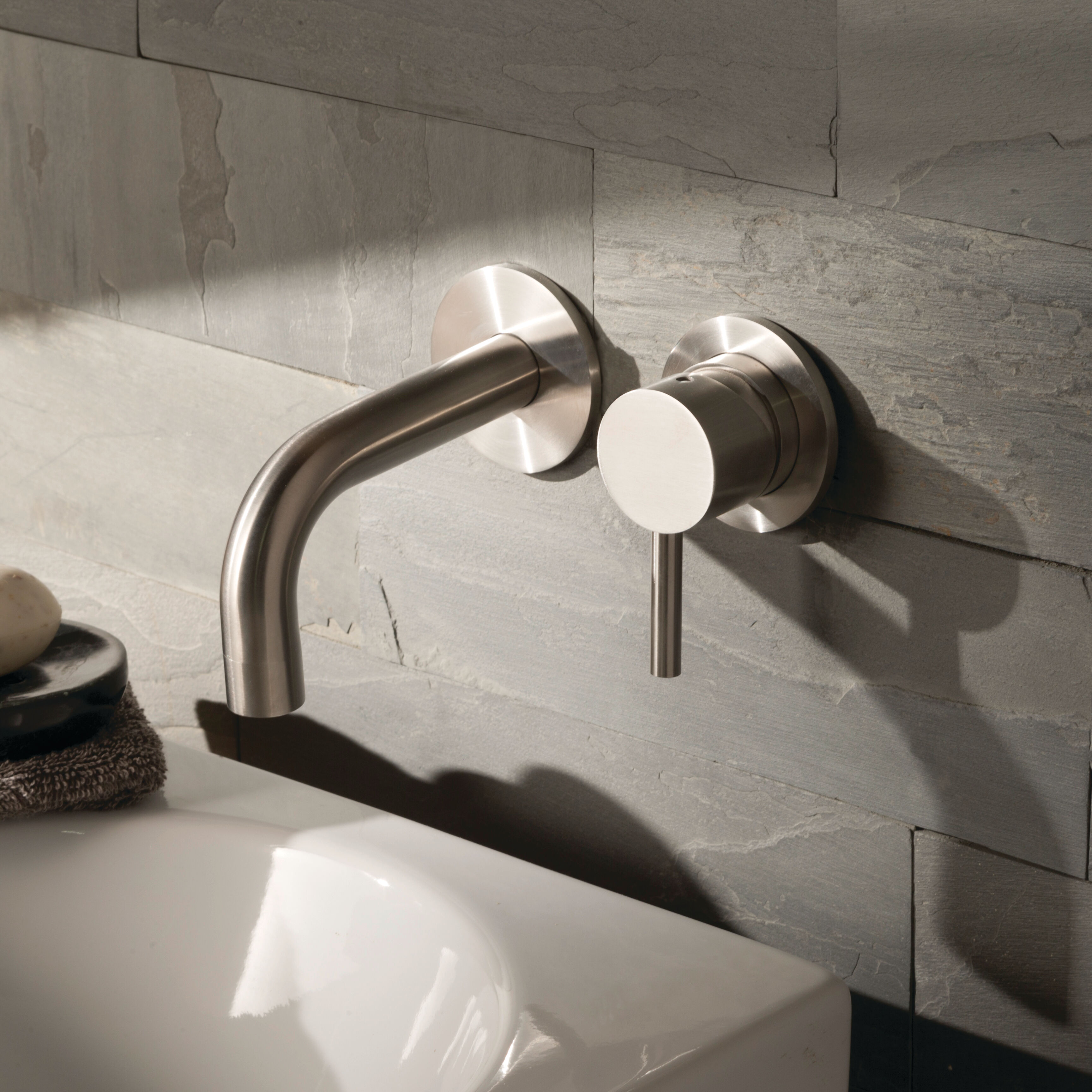 Close up product lifestyle image of JTP Inox Brushed Stainless Steel 2TH Wall Mounted Basin Mixer