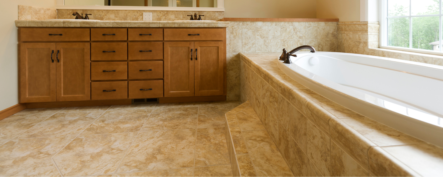 image of travertine tiles in a bathroom with golden brown wood furniture and inset bath