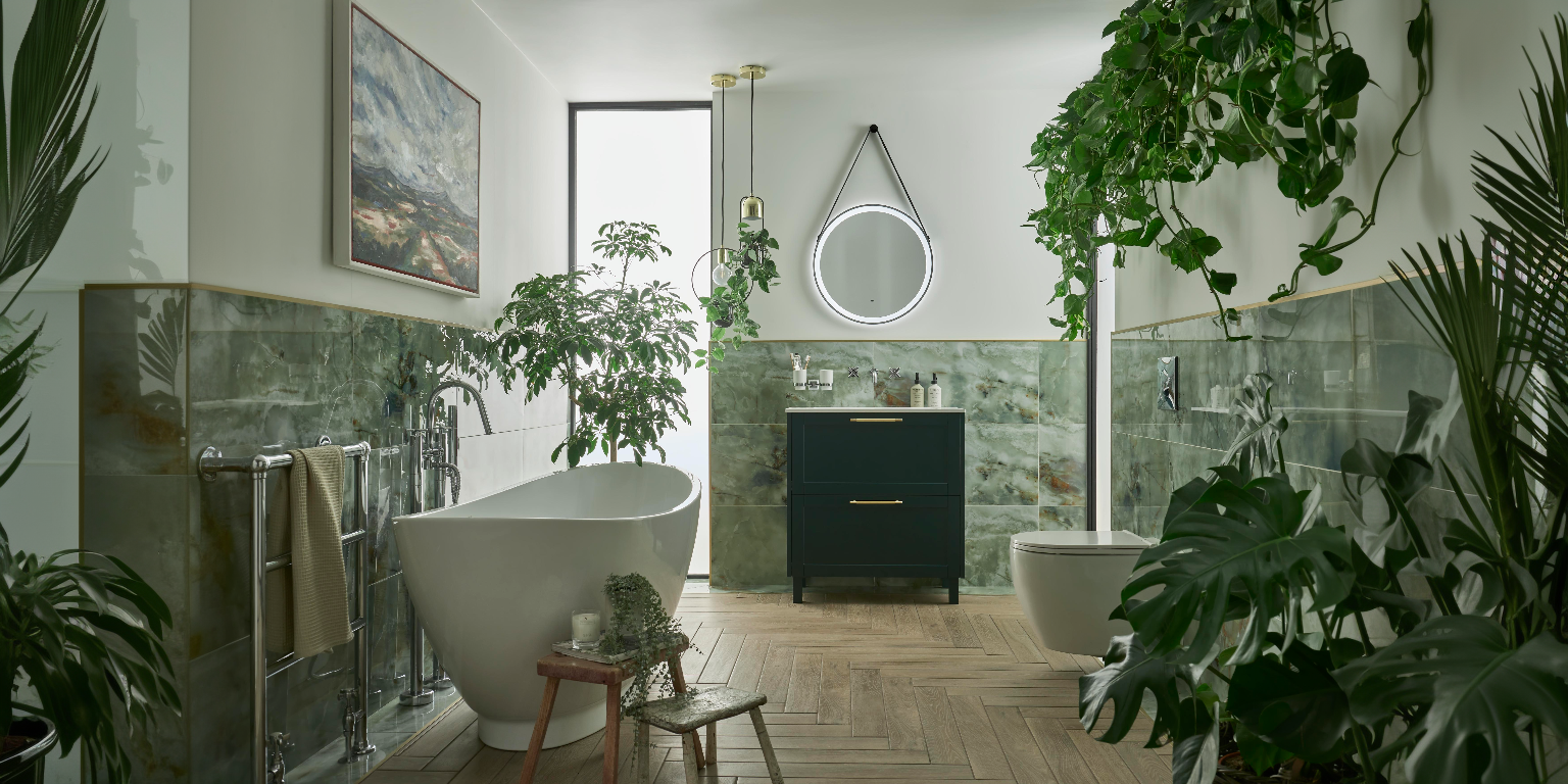 A bathroom with several plants and a Heritage Lynton Classic Green Freestanding Vanity Unit