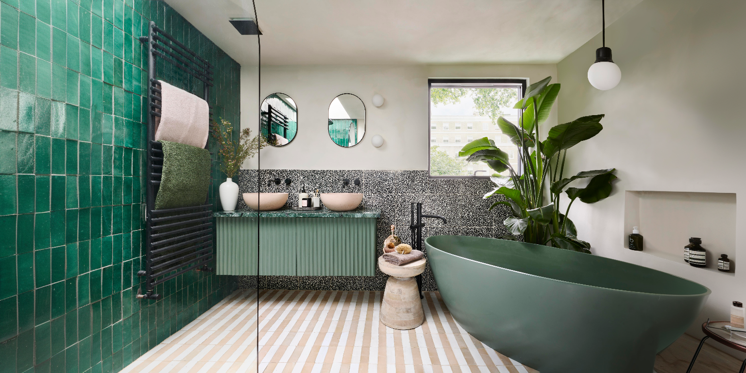A biophilic designed bathroom with freestanding bath and wall-hung vanity unit