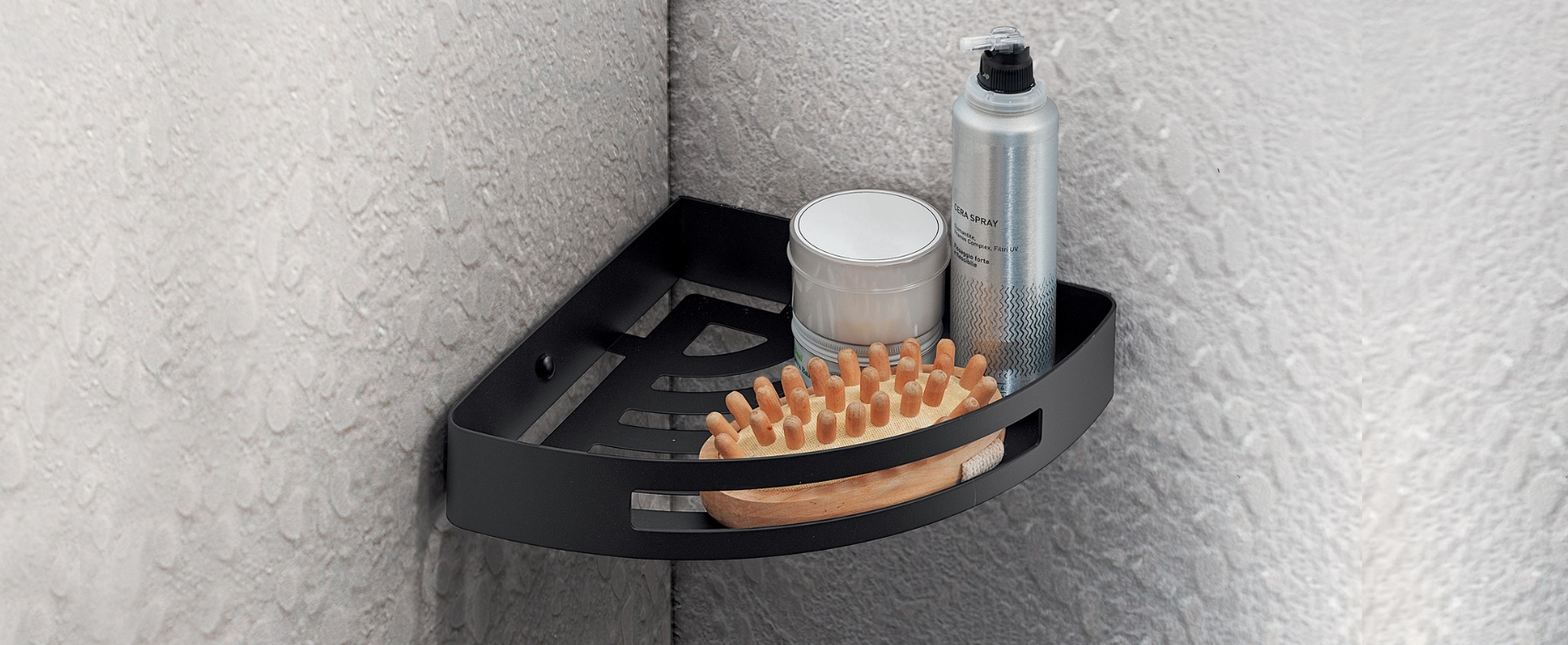 Lifestyle image of the Origins Living Nerva Matt Black Corner Shower Basket with shower essentials