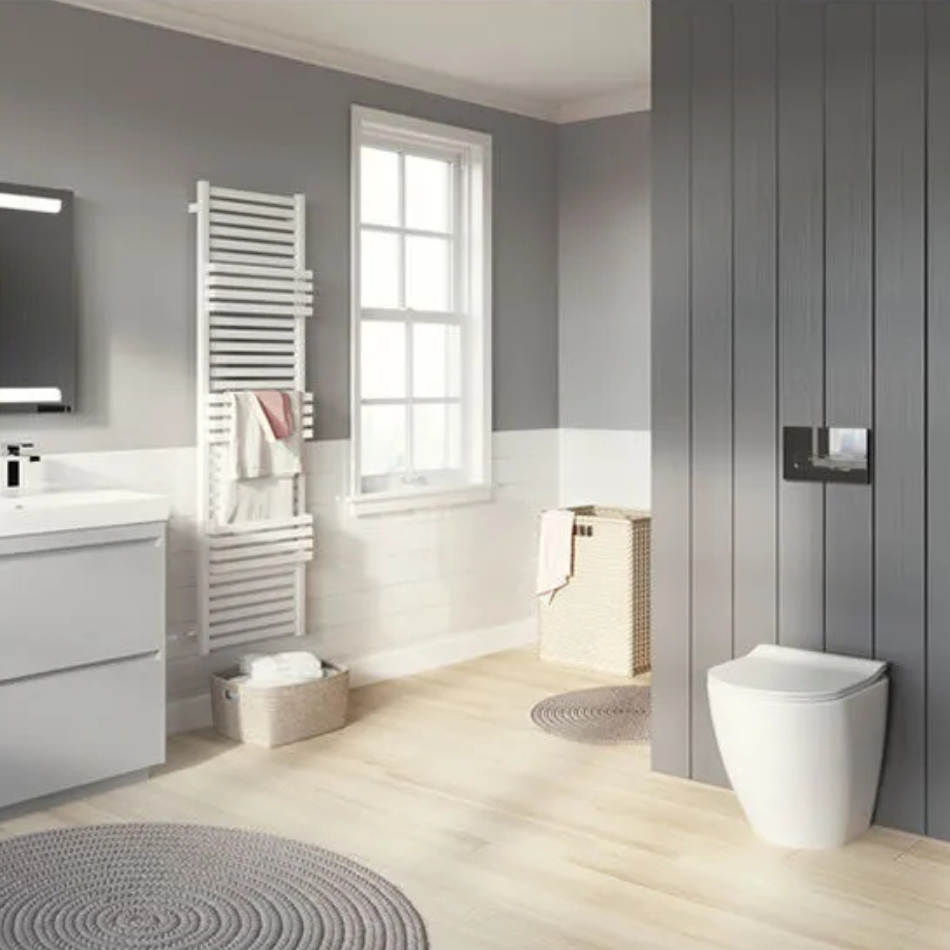 Lifestyle image of a grey themed bathroom, featuring a round grey bath mat, grey painted and panelled walls, grey washbasin unit and a grey soap dish