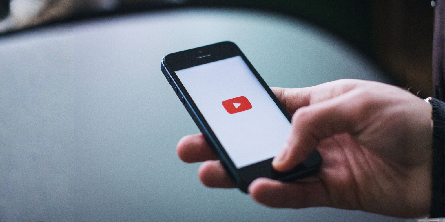 A person streaming videos on their mobile phone