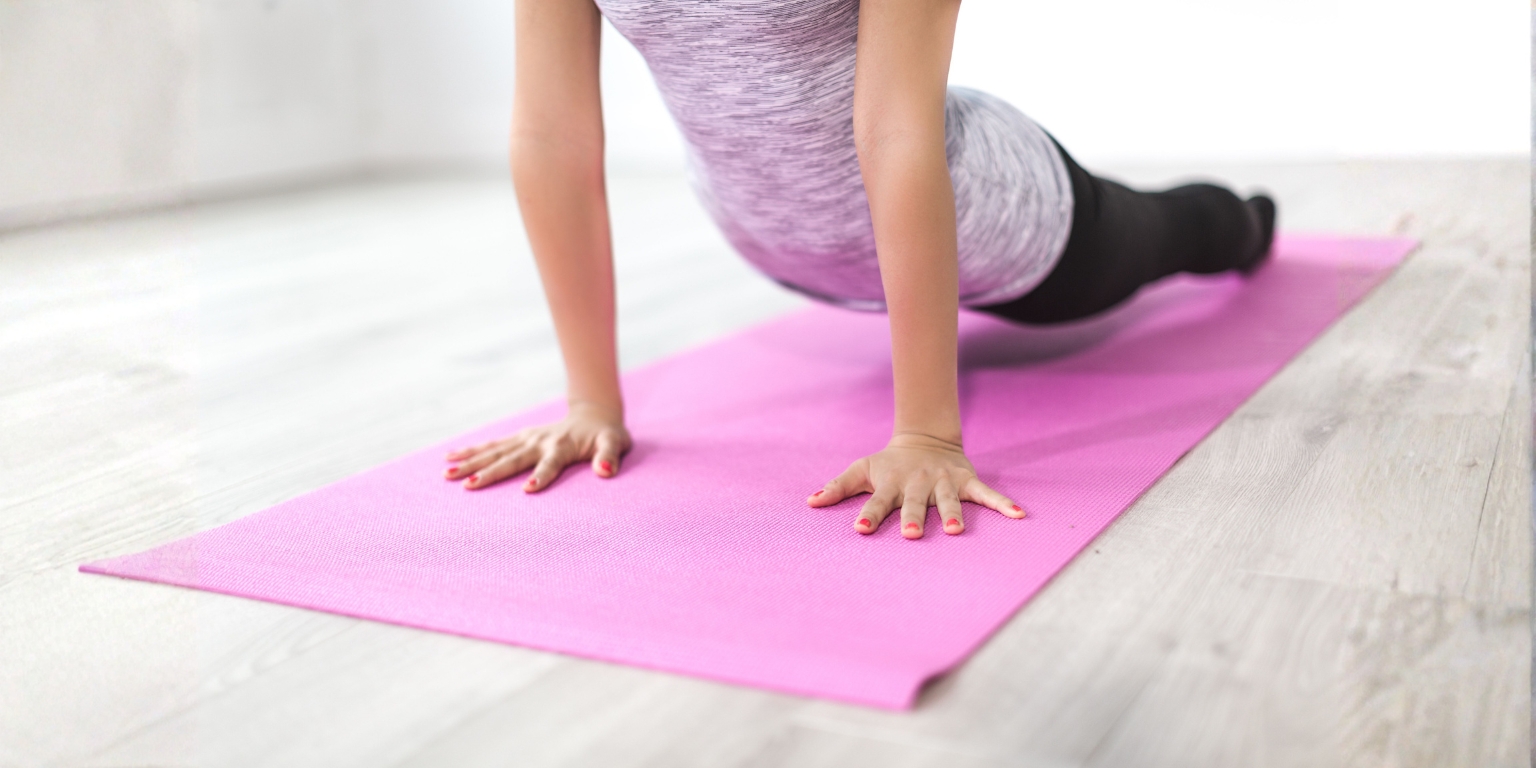 A person practicing yoga on a yoga mat