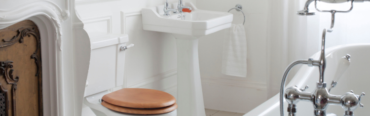 Close up lifestyle image of pedestal basin in a white tiled bathroom