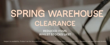 banner saying spring warehouse clearance reduced whilst stocks last on blurred background of a plant in front of a bath