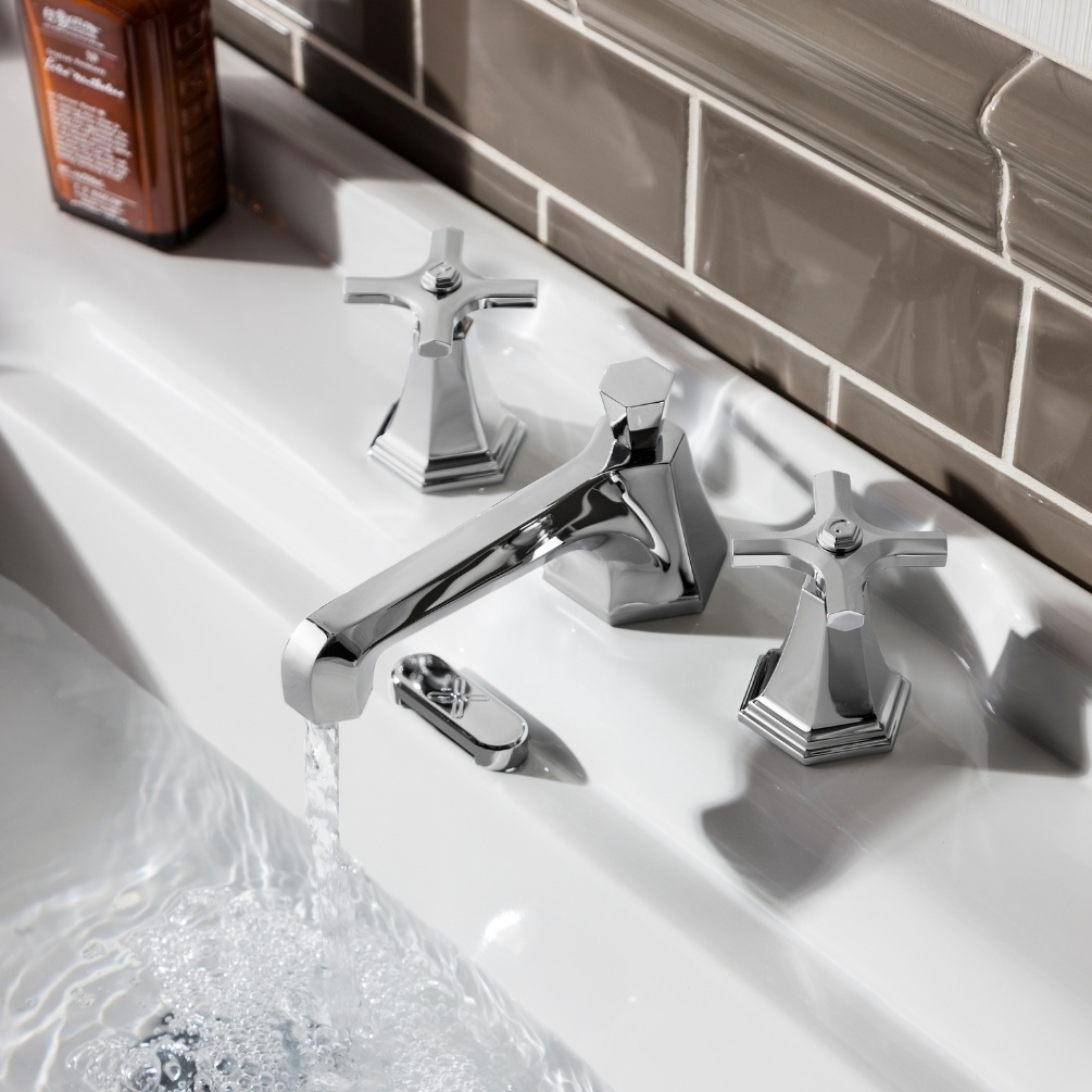Lifestyle image of the Crosswater Waldorf Chrome 3 Tap Hole Crosshead Deck Mounted Basin Mixer running water and mounted on the deck of a traditional basin