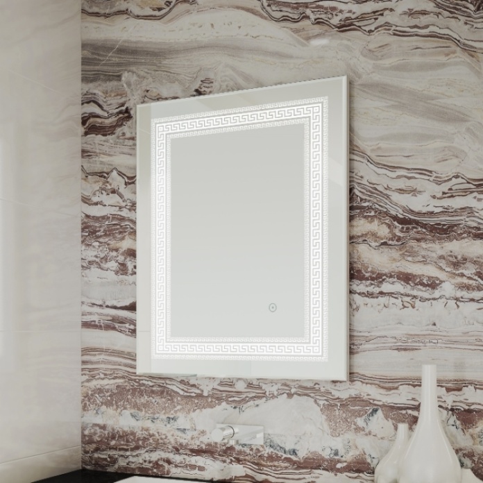 Lifestyle image of Origins Living Athenian Mirror with a patterned feature wall background and decorative ornaments