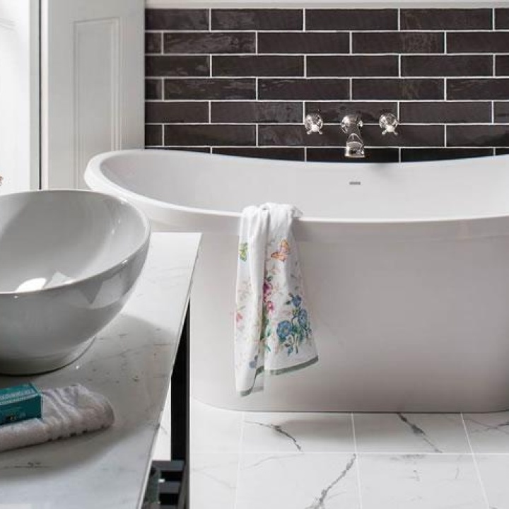 Lifestyle image of a boat bath with a seemingly paint splattered towel draped over its rim