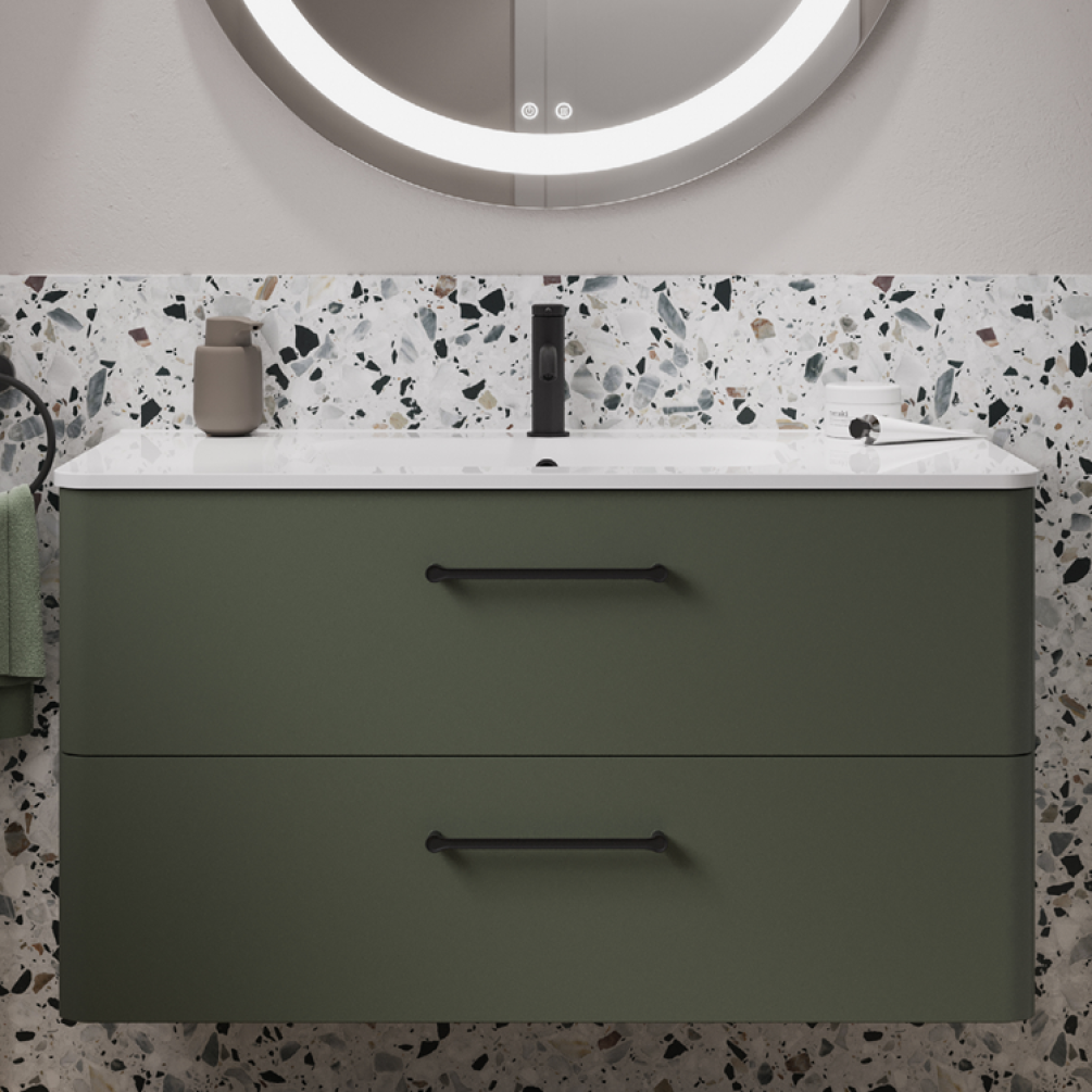 Product lifestyle image of Britton Bathrooms Camberwell Earthy Green Wall Hung Vanity Unit with Basin in Bathroom with black handles close up front angle with illuminated mirror