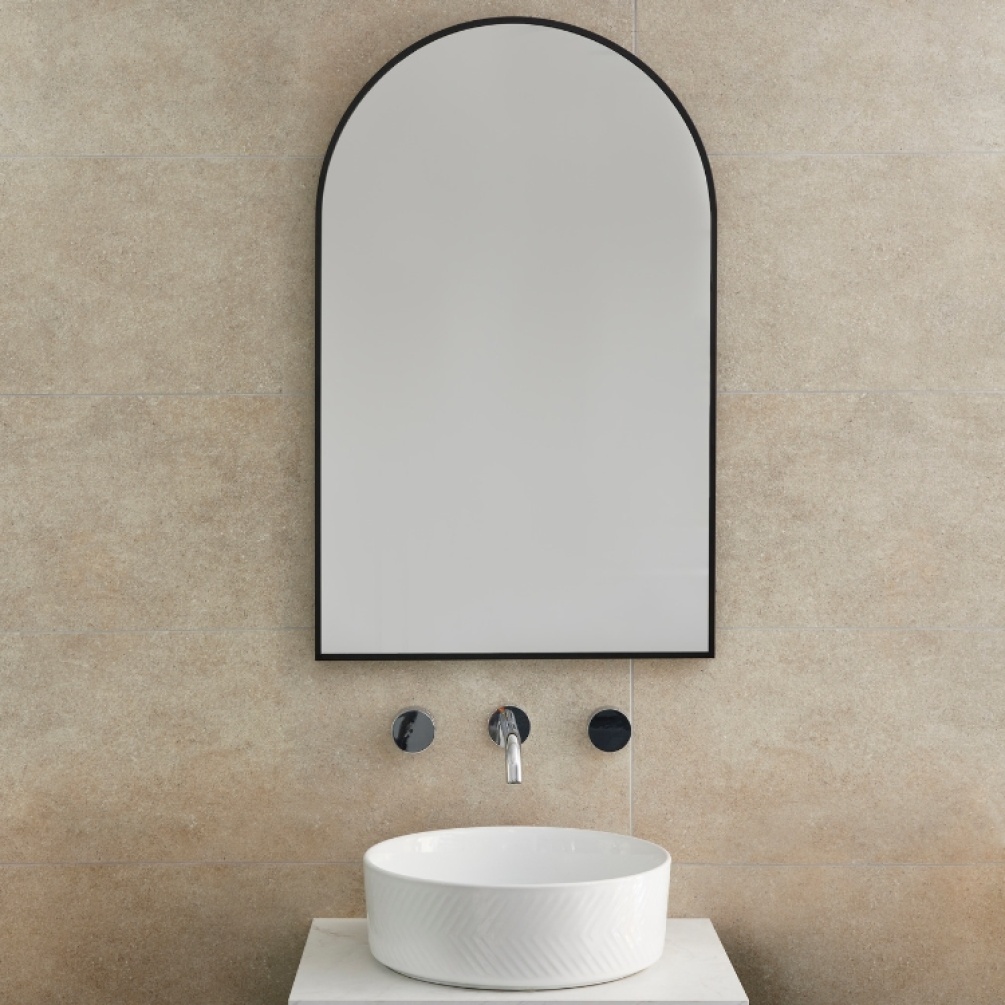 Product Lifestyle image of Origins Living Docklands 500mm x 800mm Black Arch Mirror in front of a 3-hole tap. DKL-00R058-BK